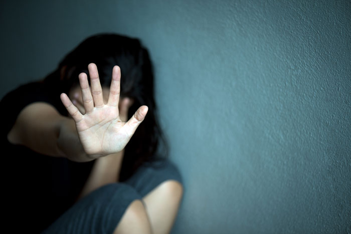 A compassionate female therapist in Singapore offering support to a distressed woman during a sexual trauma counselling session at Insightful Counselling.