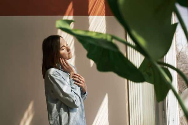 A counsellor engaging in self-care activities like meditation and journaling, emphasizing the importance of mental wellness in Singapore.