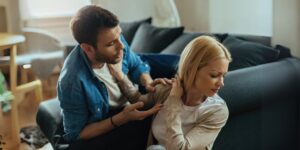 Couple experiencing emotional distance during an argument at home, highlighting relational tension in PTSD-affected relationships - Insightful Counselling